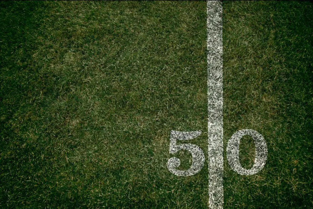 American Football 50 yard line football field and game (stock)