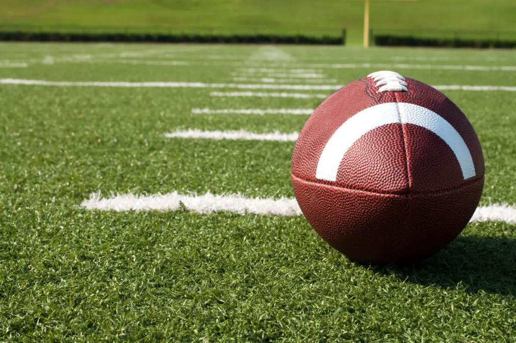 Closeup of American Football on Field (stock)