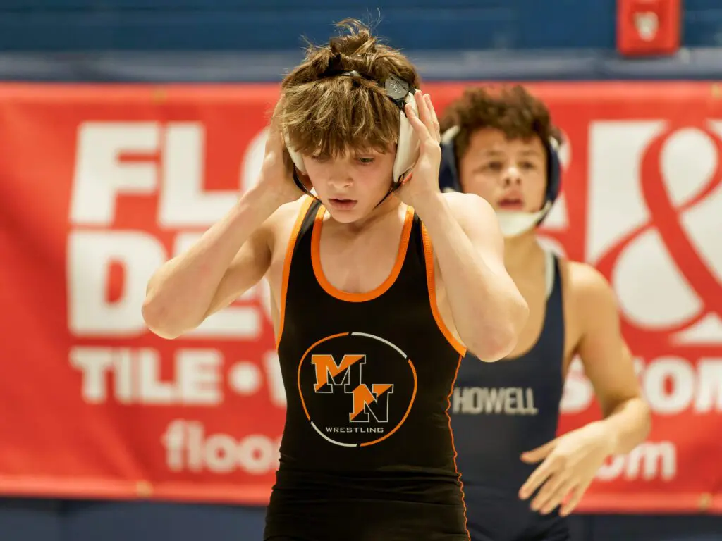 Middletown North's Thomas Blewett adjusts his head gear during the 2024 Shore Conference Tournament 106-pound quarterfinals at Middletown High School South. (Bob Badders | rpbphotography.com)