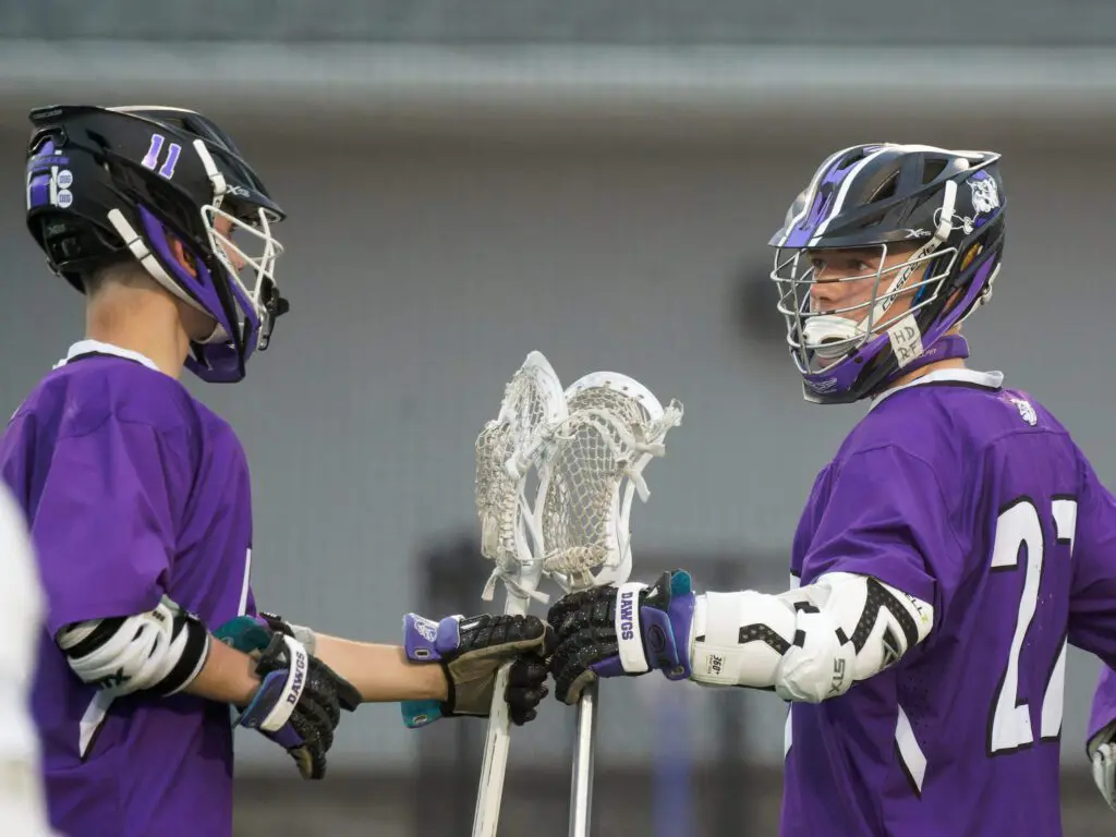 Junior attackman Luke Lydon (27) and freshman attackman Teddy Whitehouse celebrate a goal during Rumson-Fair Haven's 15-6 win over Holmdel in the quarterfinals of the Shore Conference Tournament. (Bob Badders | rpbphotography.com)