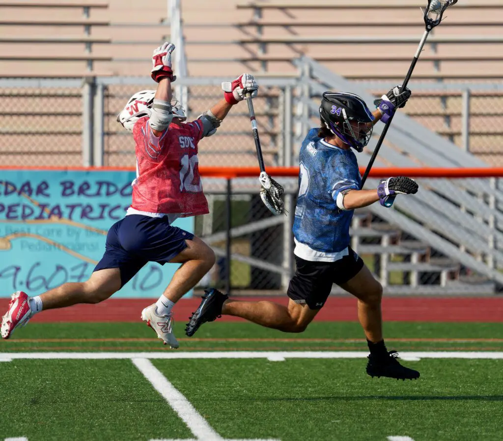 Shore Conference Boys Lacrosse Senior All-Star Game, June 12, 2025 - Shore Sports Insider Wall's Michael Hoarle leaps for a check attempt on Rumson's Frank Argilagos. (Bob Badders | rpbphotography.com) - Shore Conference Boys Lacrosse Senior All-Star Game, June 12, 2025