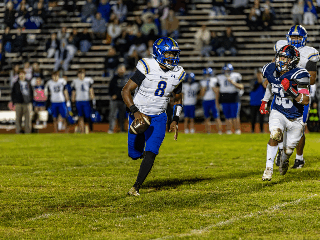 Donovan Catholic junior quarterback Kahden Davis scrambles against Manalapan (Photo by Doug Phillips/https://framegrabsllc.com/)