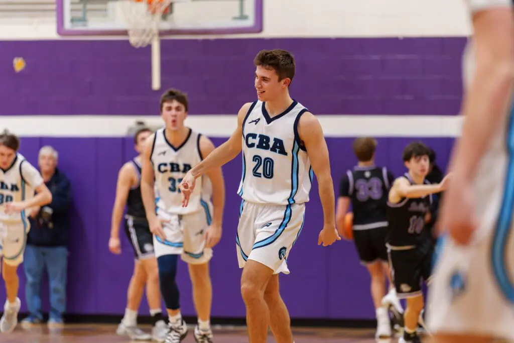 CBA senior Charlie Messano reacts after hitting a three-pointer as senior teammate Connor Andree celebrates behind him. (Photo: Patrick Olivero)