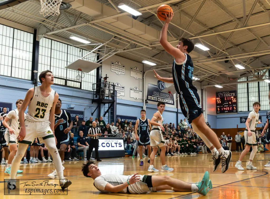 CBA senior Connor Andree shoots over Red Bank Catholic senior Ryan Saxton as junior Tyler Hager (23) looks on. (Photo: Tom Smith | tspsportsimages.com)