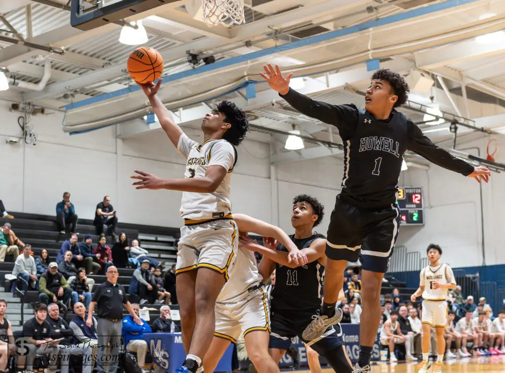 Marlboro senior Ajay Mathews goes up for a layup around Howell's Cayden Parker (1) and Jayson Parker. (Photo: Tom Smith | tspsportsimages.com)