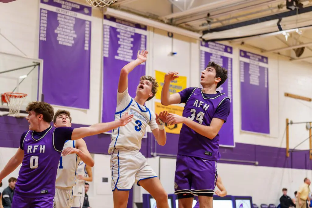 Holmdel senior Connor Paul puts up a shot over Rumson-Fair Haven seniors Luke Lydon (left) and Luke Cruz (Photo: Patrick Olivero)