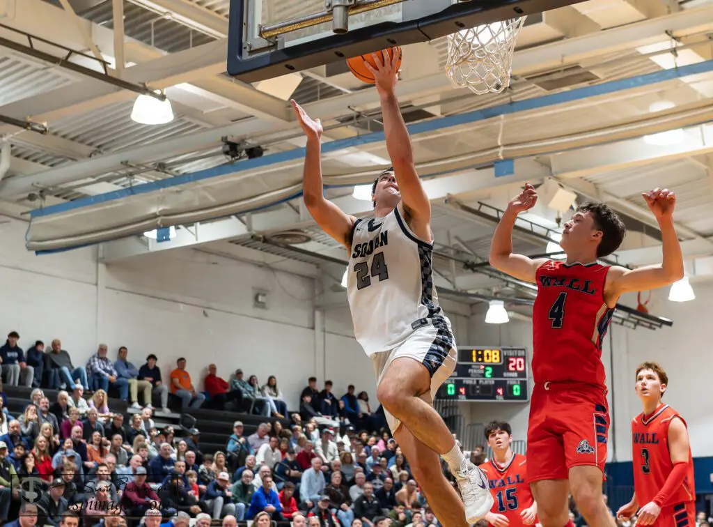 Manasquan senior Jack O'Reilly drives for a layup against Wall senior Dan Hennessy. (Photo: Tom Smith | tspsportsimages.com)